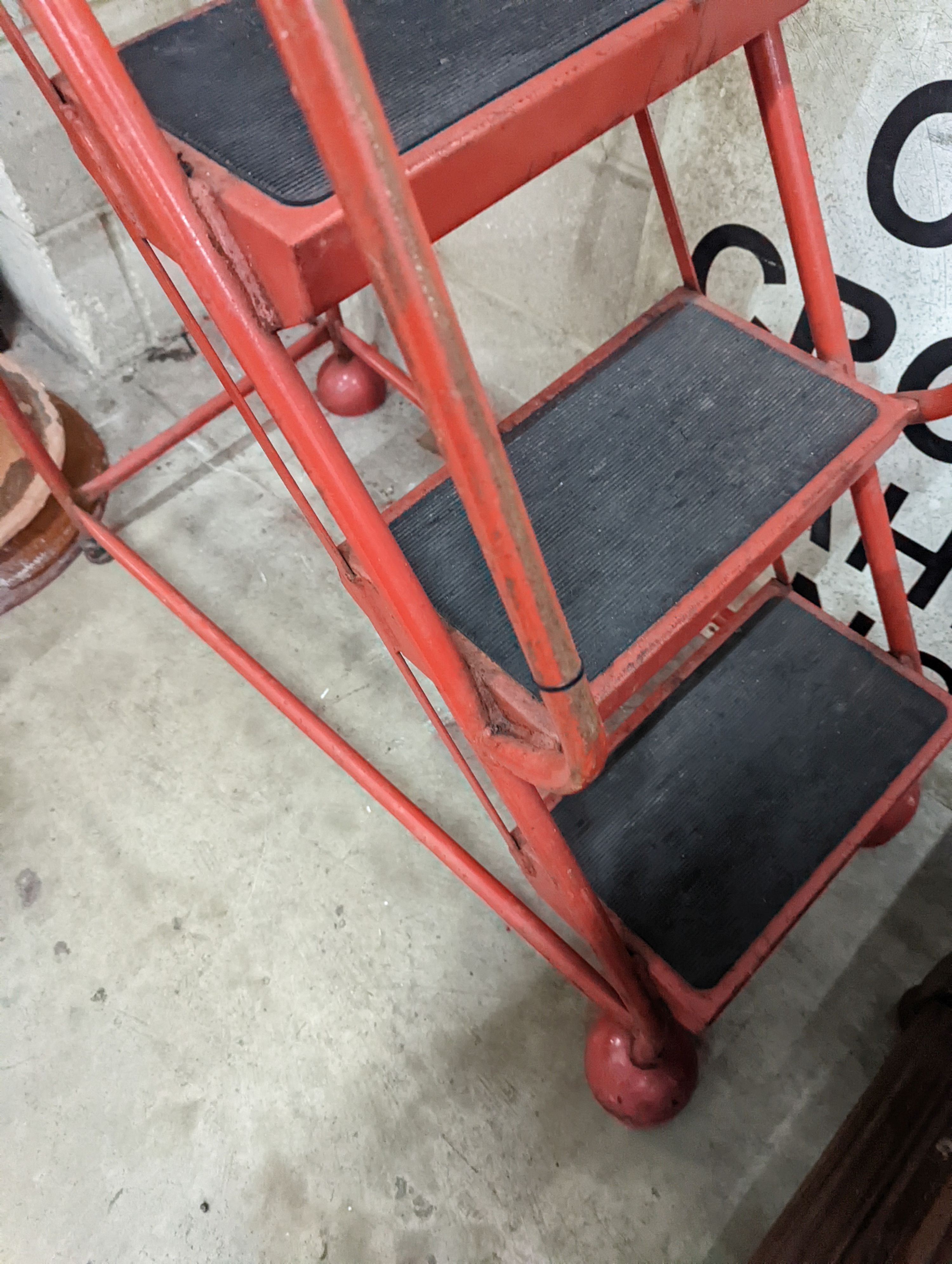 A set of red painted metal steps, height 188cm